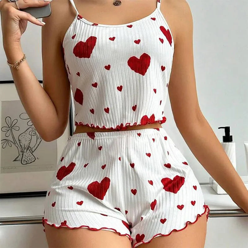 Women's summer pajamas set featuring a soft tank top and shorts with heart print, perfect for stylish sleepwear.