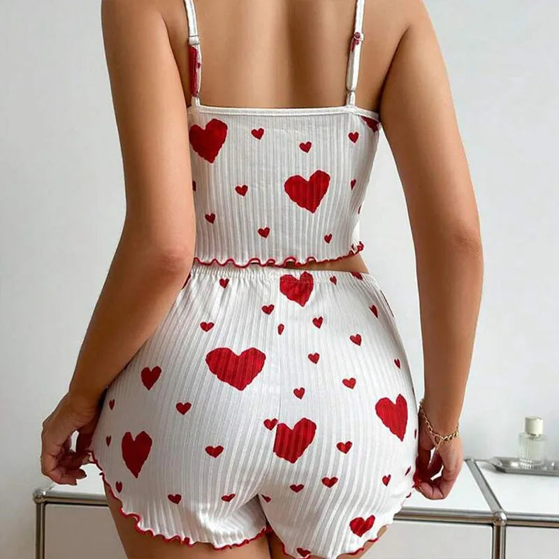 Women's summer pajama set with heart patterns, featuring a soft tank top and shorts for comfortable lounging.