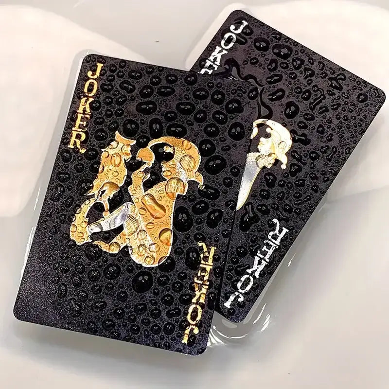 Waterproof Joker playing cards with gold detailing and water droplets, perfect for game nights and card collections.