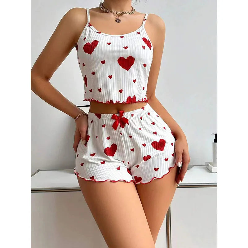 Women's summer pajamas set featuring a soft tank top and shorts with red heart patterns, perfect for warm nights.