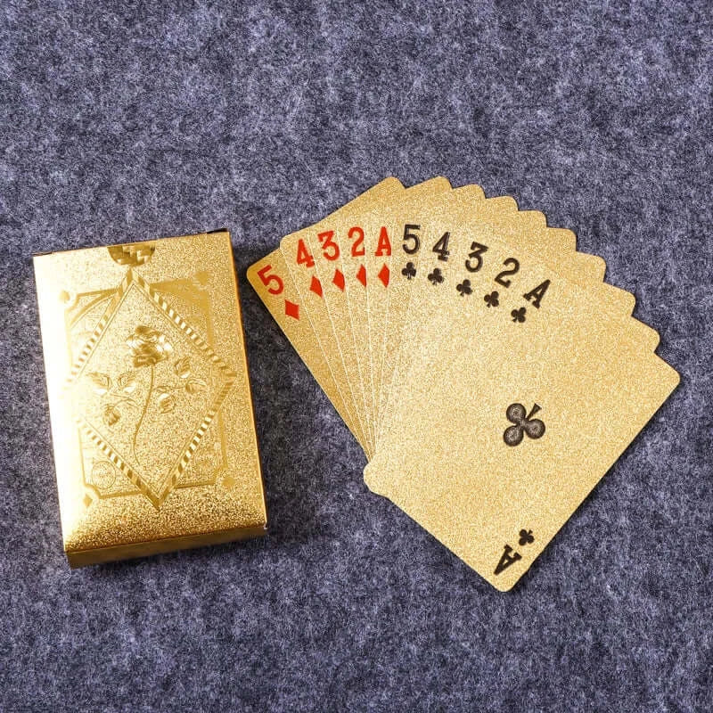 Waterproof gold playing cards spread out with ornate case, ideal for poker and gift giving.
