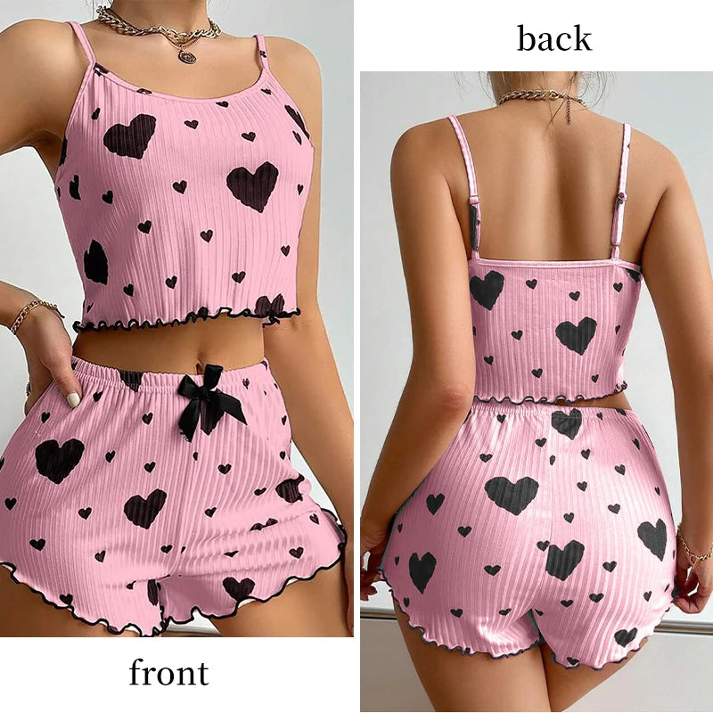 Women's summer pajamas set in pink with black hearts, featuring a tank top and matching shorts, displayed from front and back.
