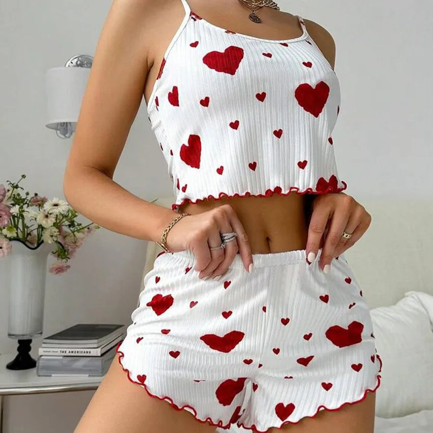 Women's summer pajamas set featuring a soft tank top and shorts with heart prints, perfect for cozy lounging.